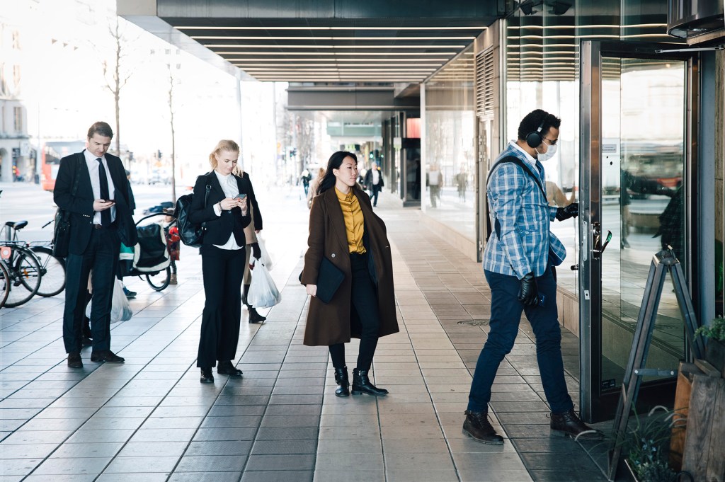 Consumers in line to enter a business