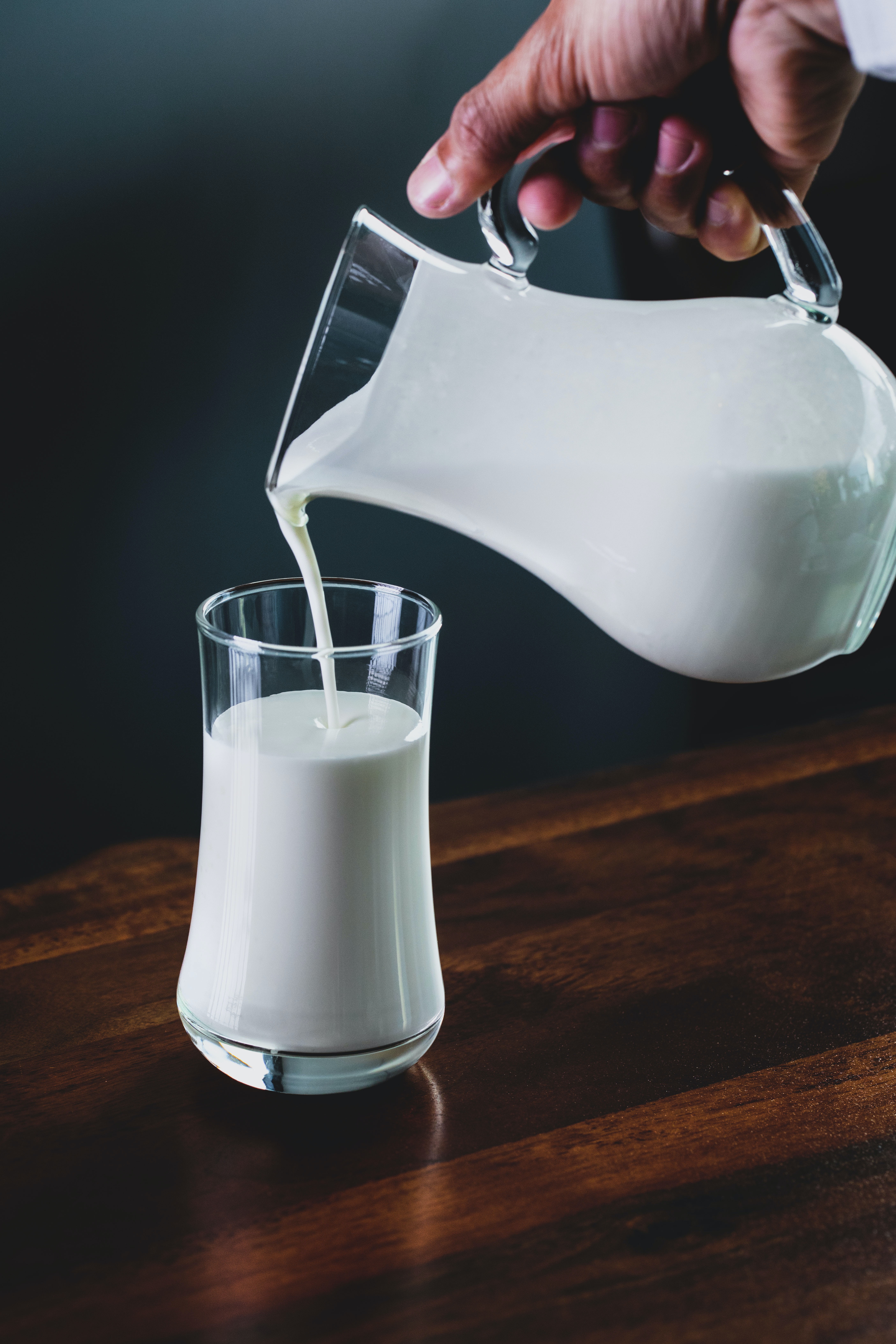 Milk pouring into a cup