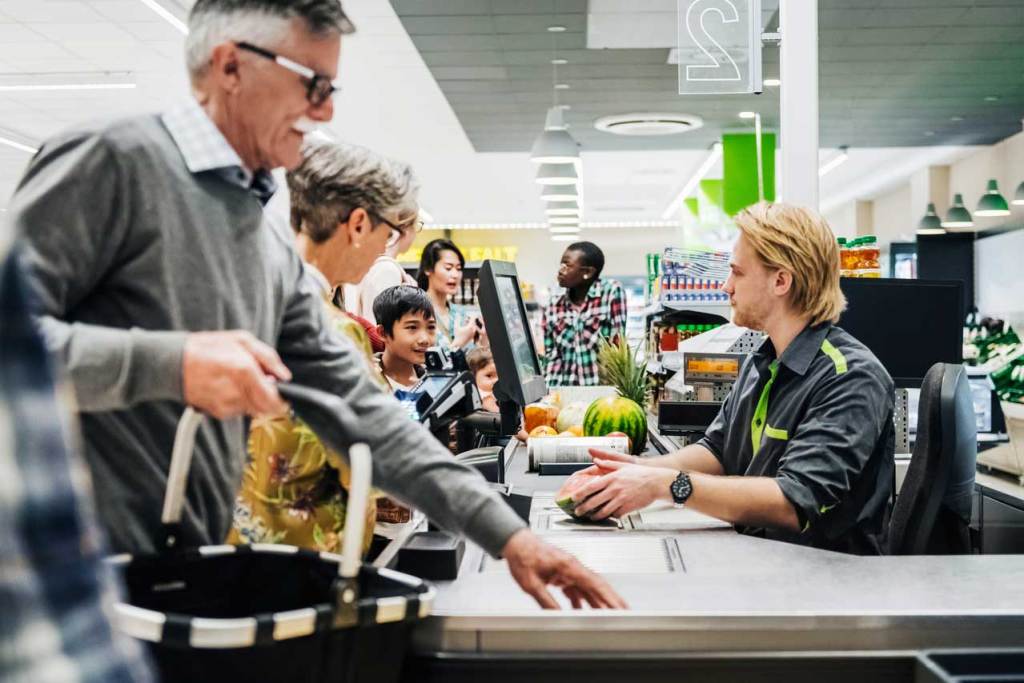 Clerk scans items at grocery store