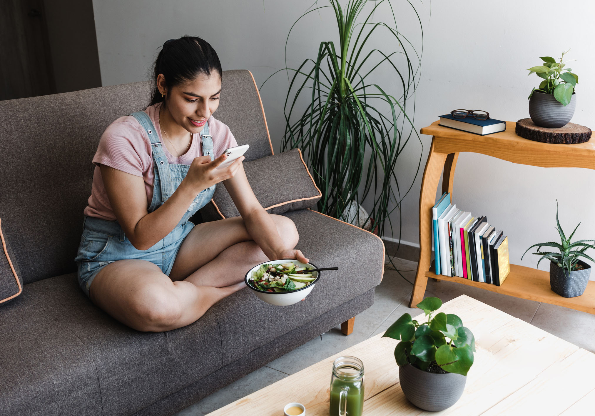 Chapter 4 of the Consumer outlook 2026​ report shows a woman looking at her phone