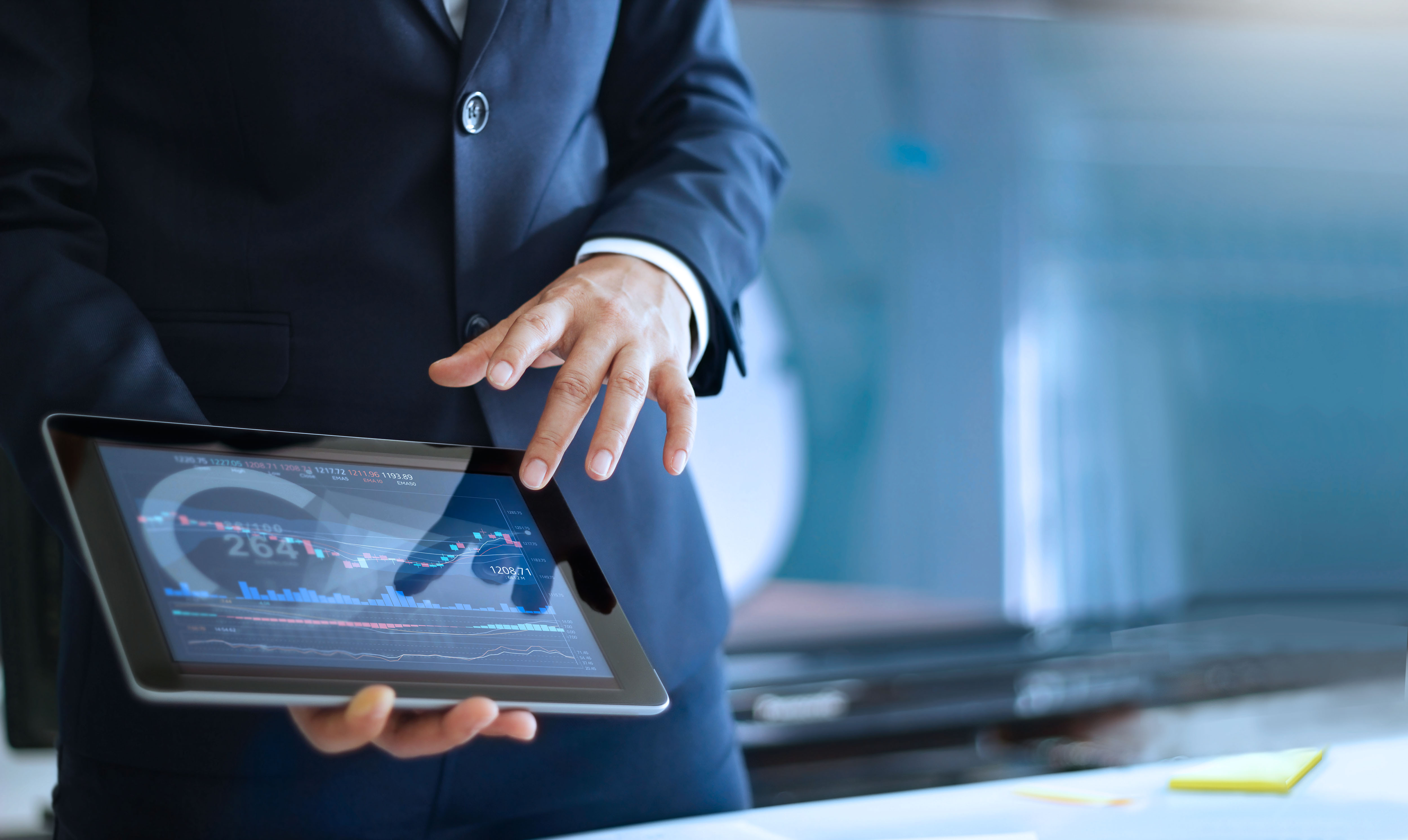 person with a tablet analyzing data