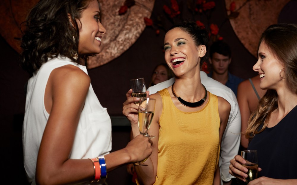 women in bar drinking champagne