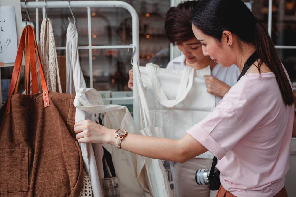 a young woman looking at sustainable cotton bags