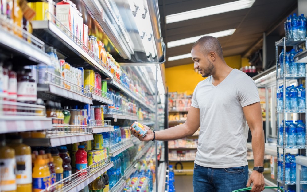 man at supermarket shopping for hard selzter beverages