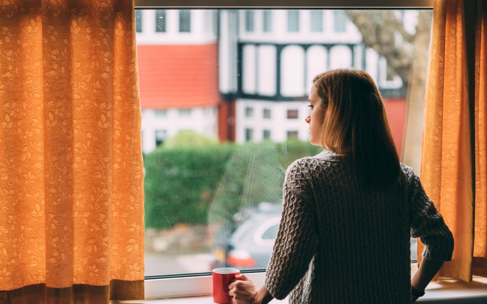 woman looking out window