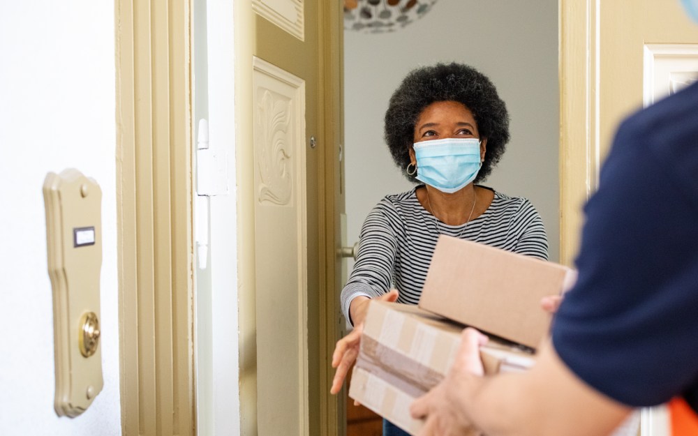 senior woman getting packages from delivery