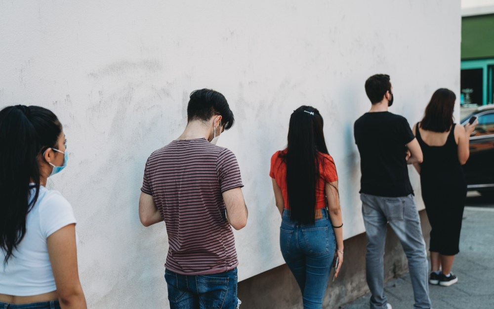 people standing in line six feet apart