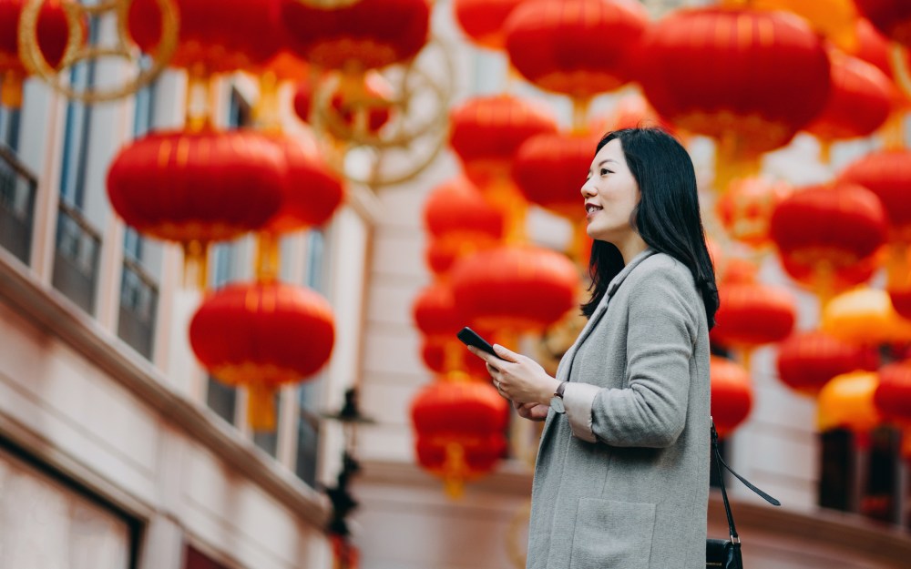 lunar new year chinese lanterns woman using mobile phone