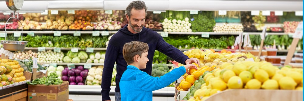 A man with his son in a grocery store