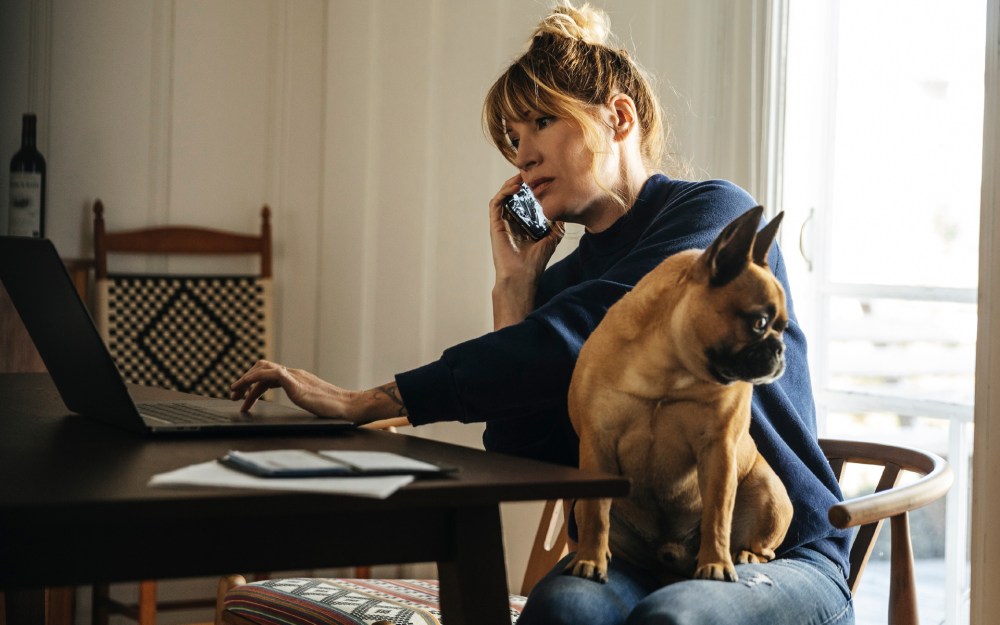 woman talking on phone with dog