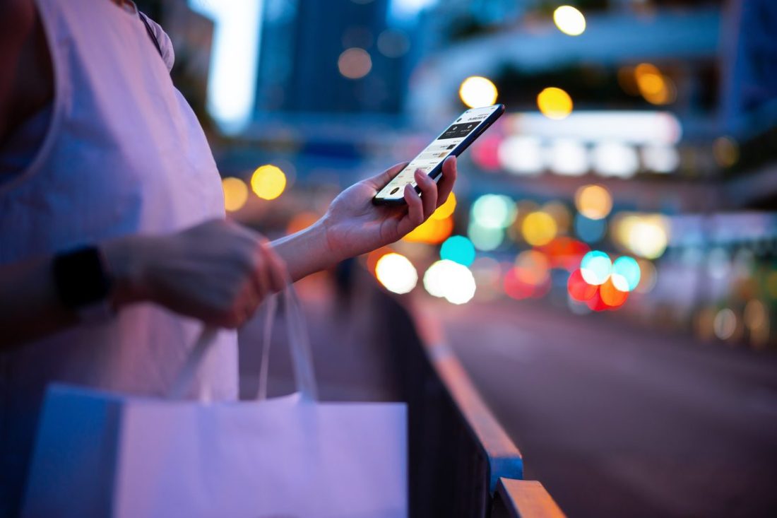 women with her phone buying stuff
