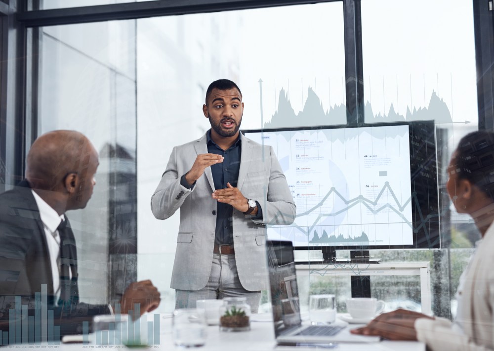 A man reviewing retail data during a presentation for work.