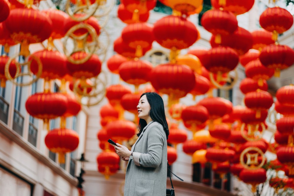 an asian woman standing in a square during a Global online shopping event