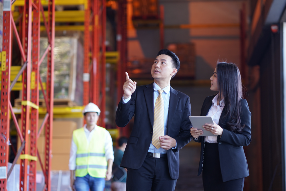 a man and woman inspecting an FMCG warehouse in Asia Pacific