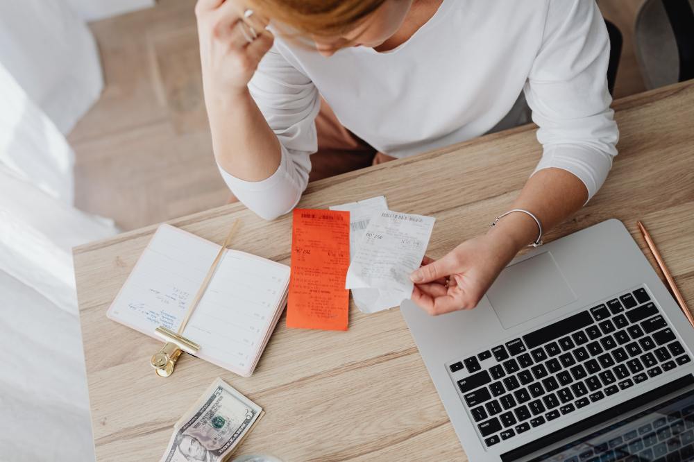 A woman looks at receipts in times of inflation