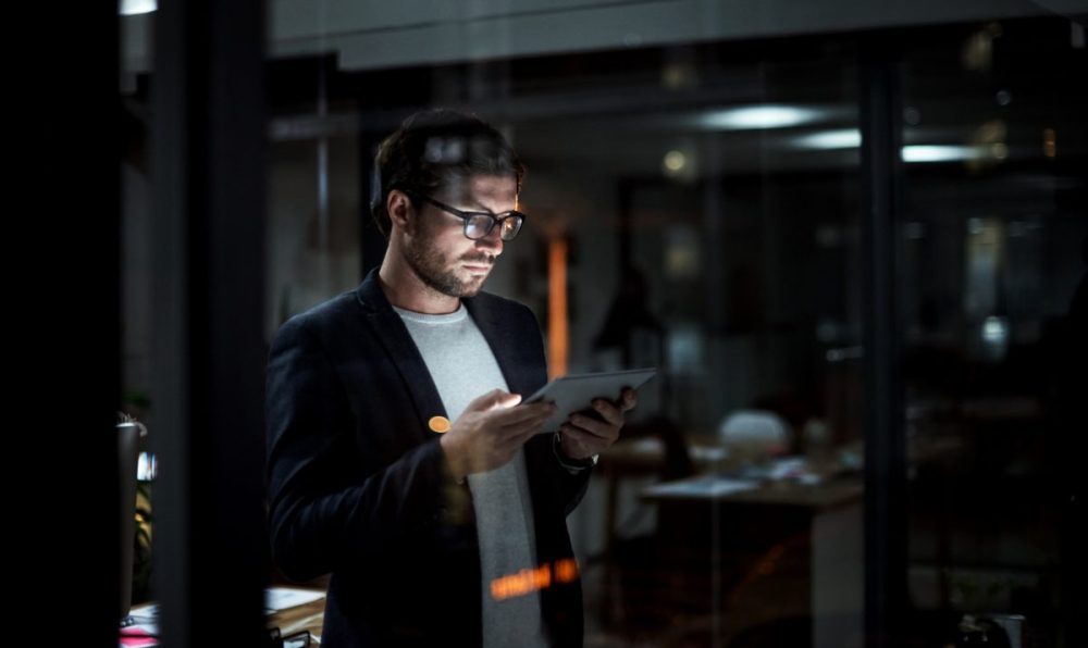 Entrepreneur looking at tablet analyzing data