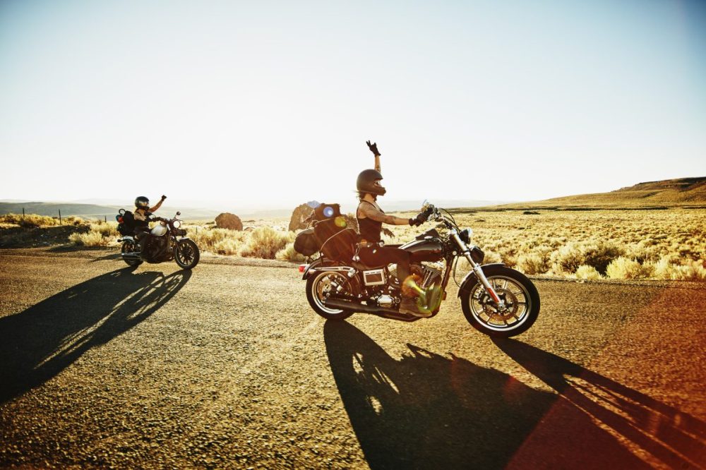 Founder riding motorcycle in the sunset