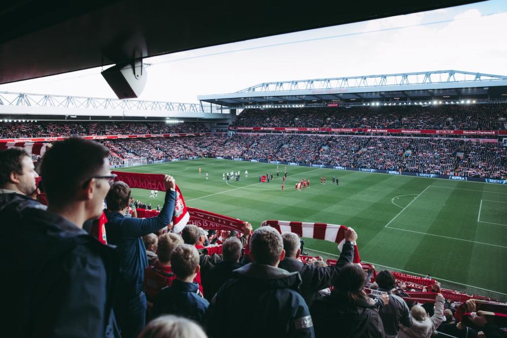people watching a soccer game in a large stadium