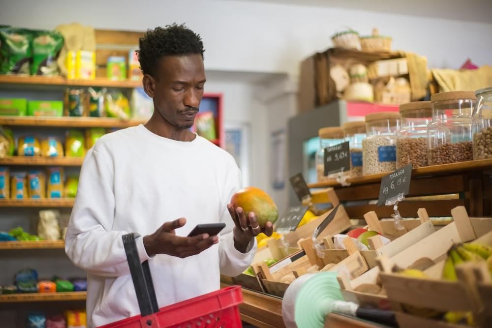 Man grocery shops in the produce department
