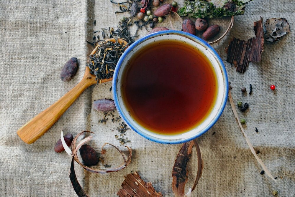 Tea cup with spoon and loose leaves