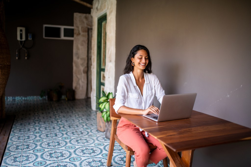 Smiling young woman working from home