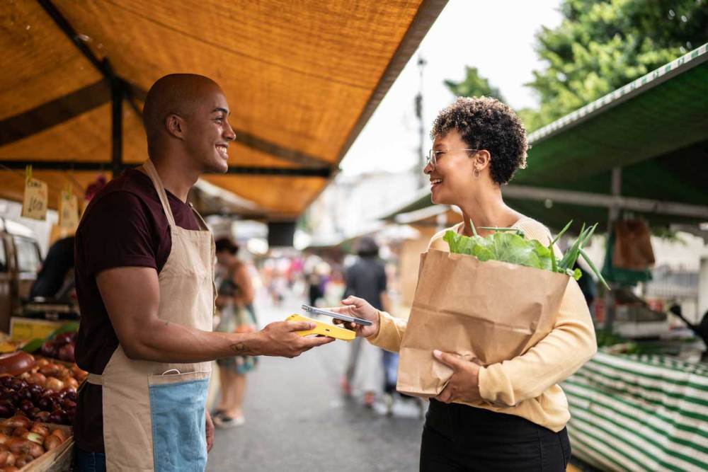 Man sells woman products at an open marketplace