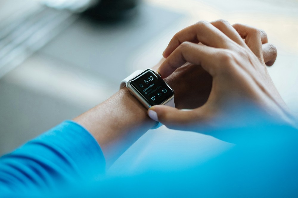person clicking smart watch