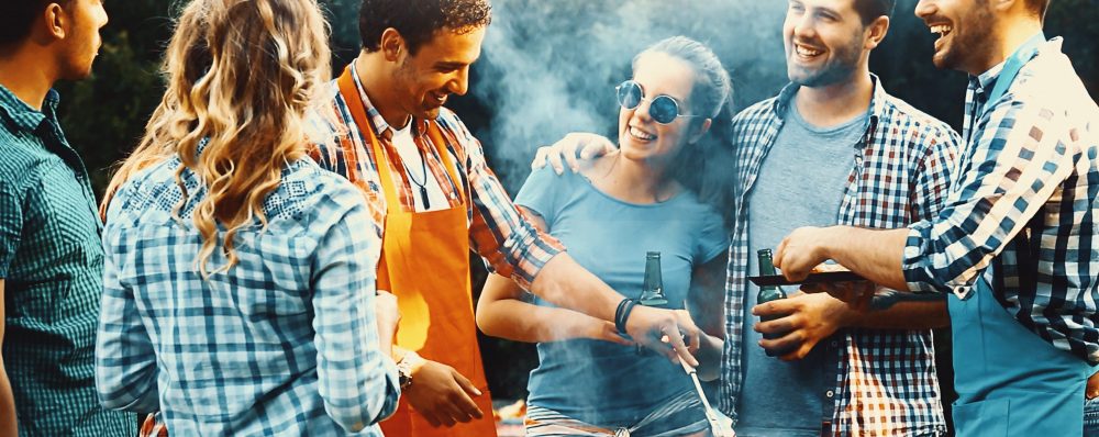 Group of friends having a BBQ outside