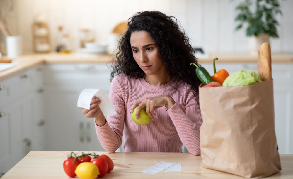 Woman looking at the receipt after grocery shopping