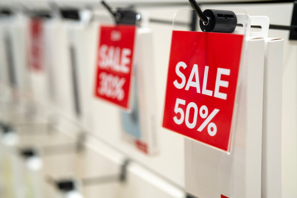 Red sales tags hanging on a shelf