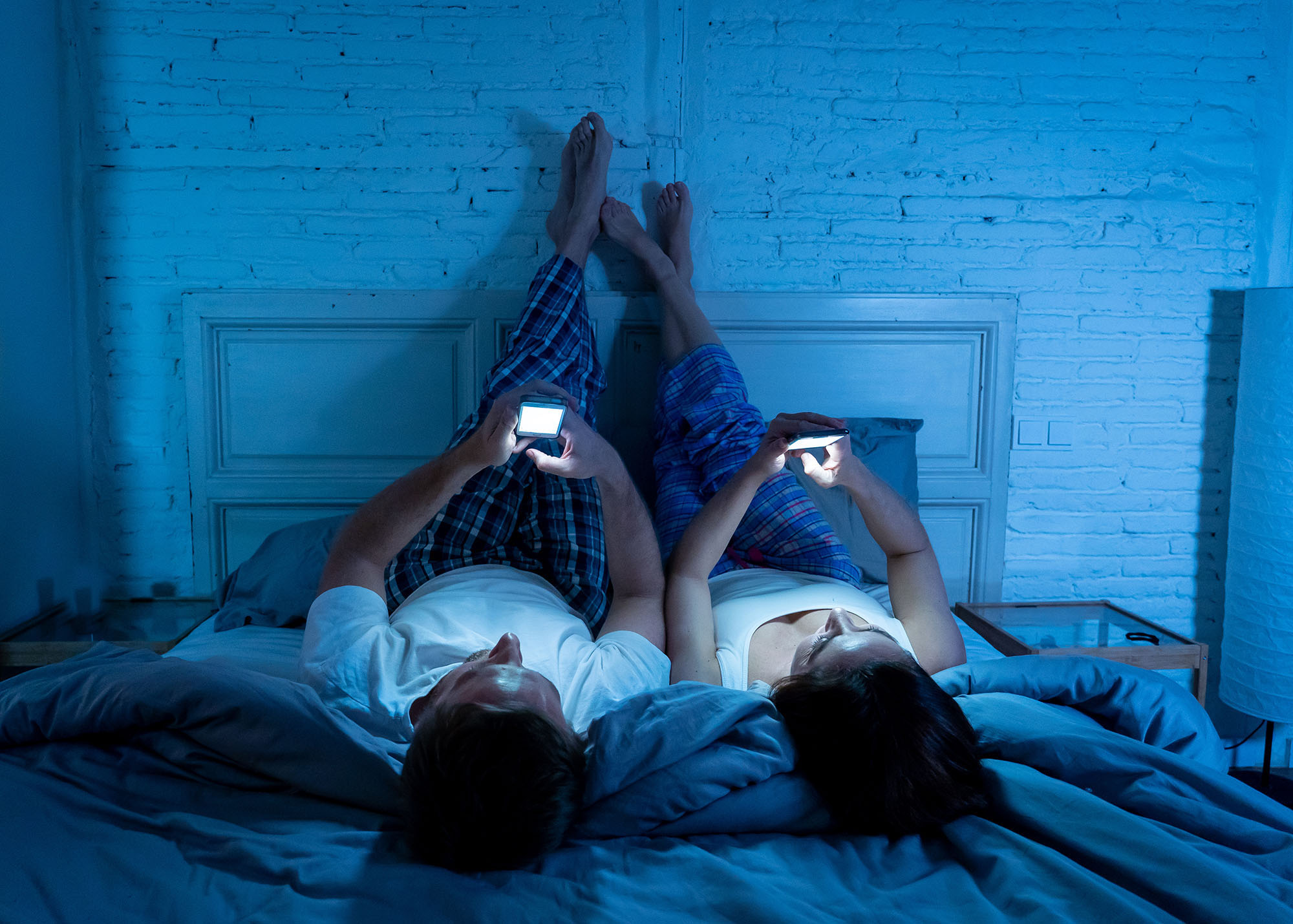 Chapter 1 of the Consumer outlook 2026​ report shows a couple looking at their phones in bed