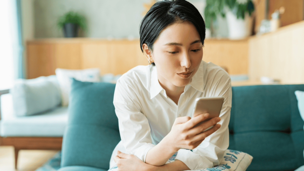 asian girl looking at her phone