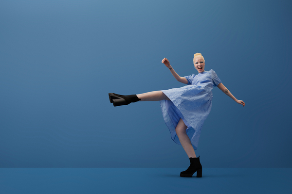 women in a blue background dancing 