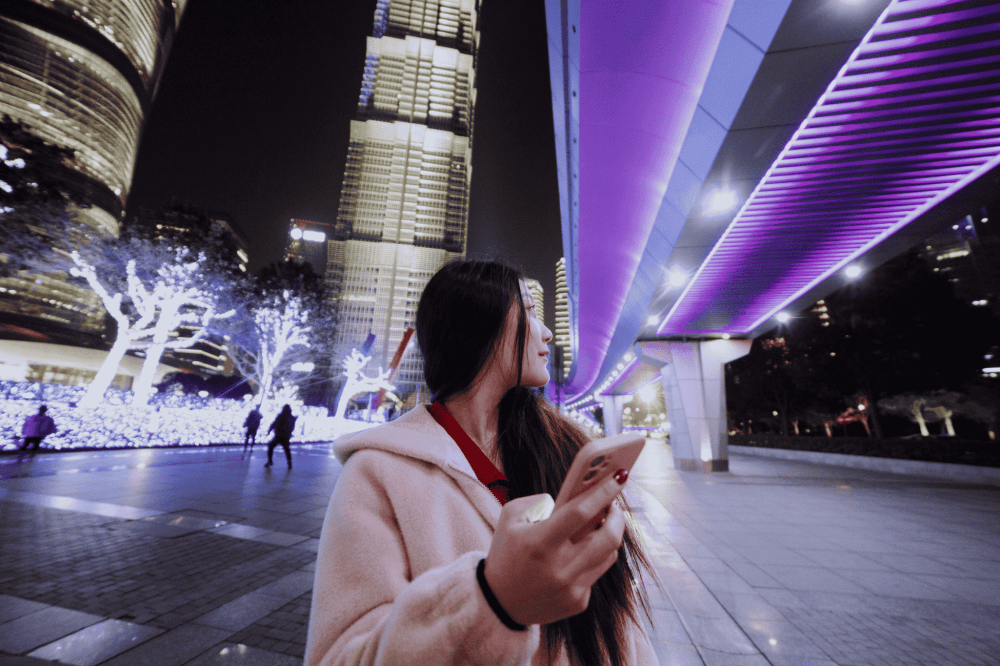 girl with her phone in a futuristic city
