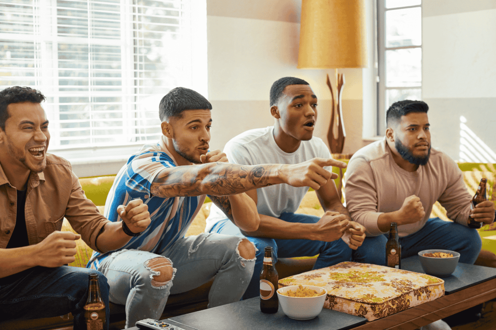 group of friends in the living room watching tv