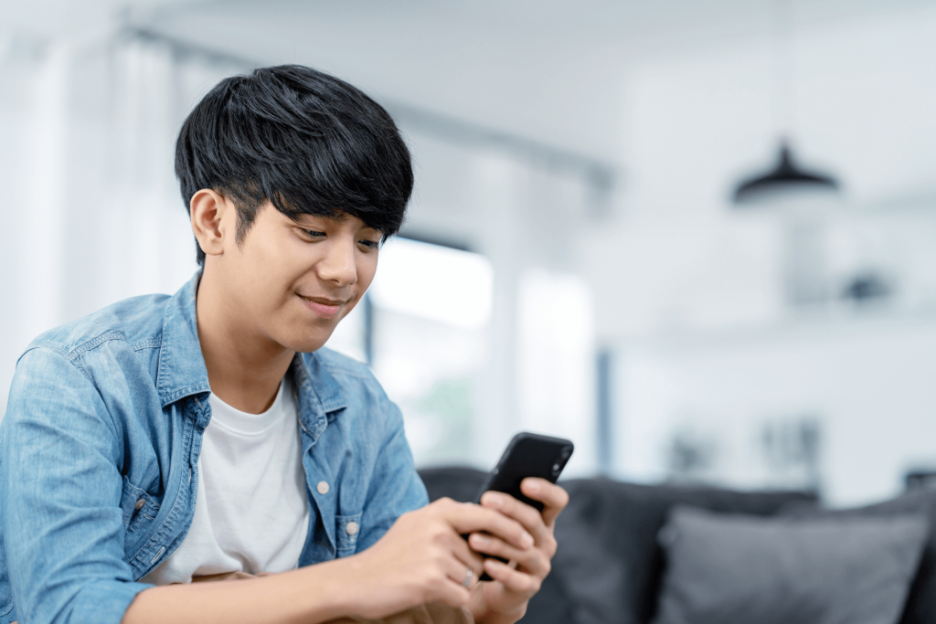Man looking at phone, blue background