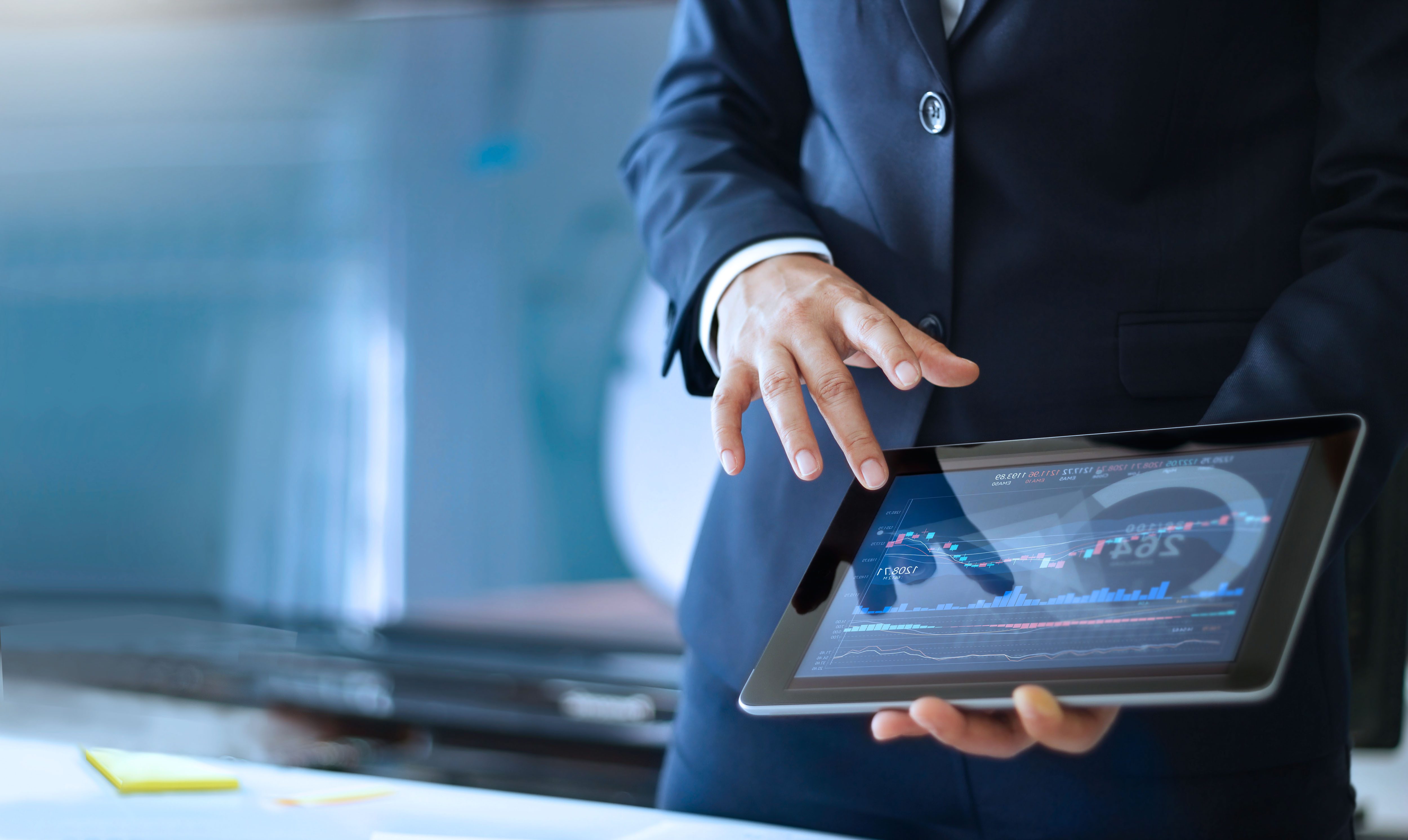 person with a tablet analyzing data