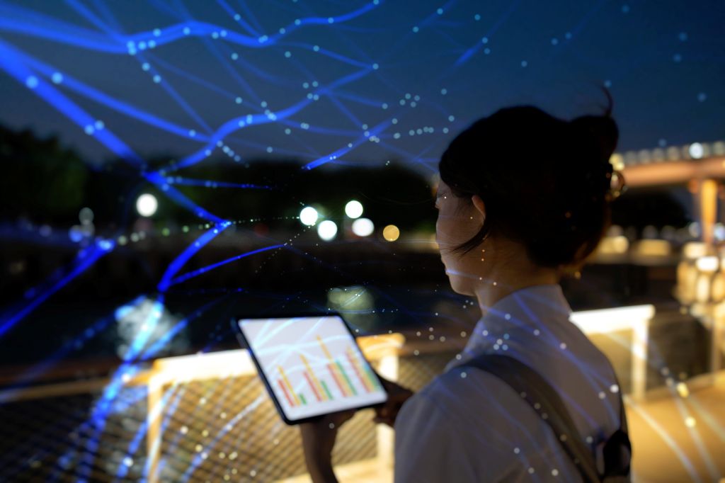 A girl looking at a tablet screen conatining data insights. 
