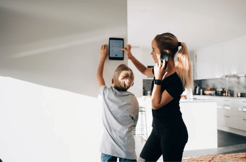 mom and her kid with a smart home panel