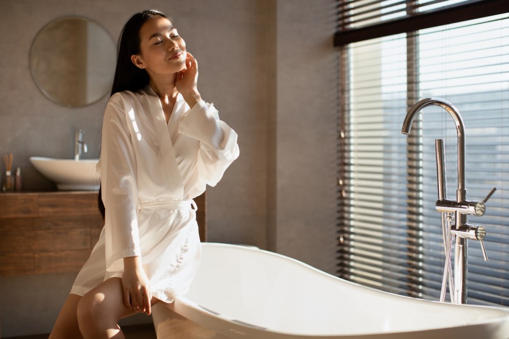 Beautiful,Young,Asian,Lady,In,Bathrobe,Enjoying,Sunny,Morning,,Sitting