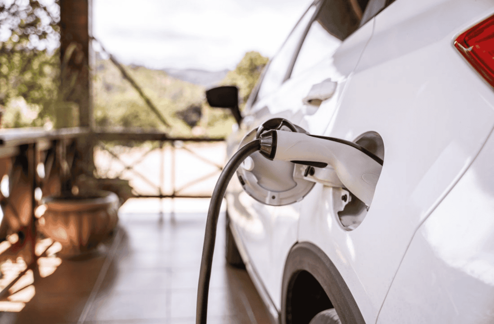 white electric car being charged