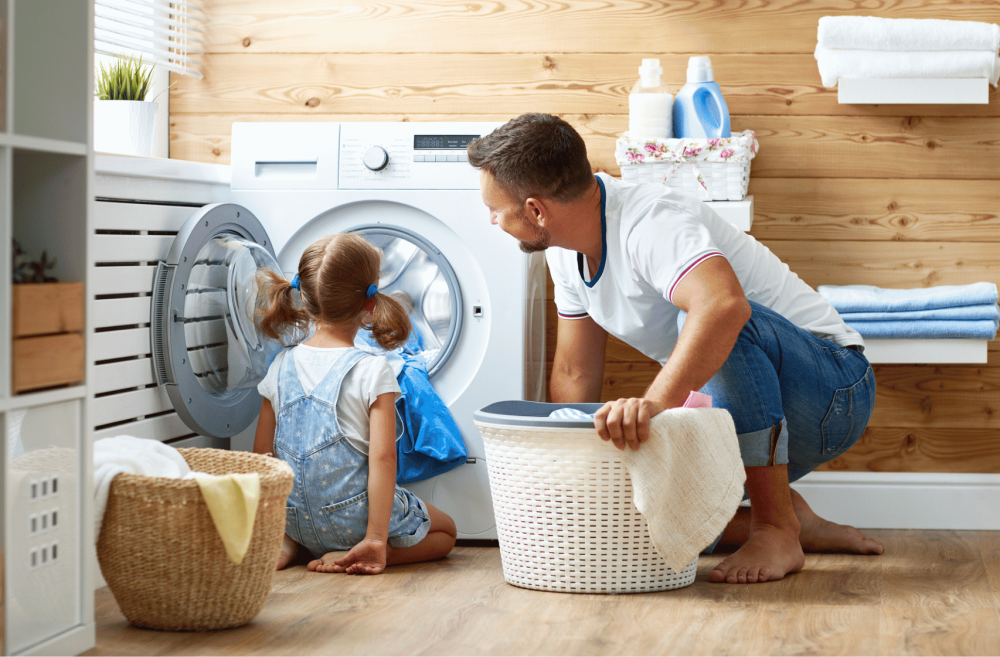 father with her kid in the laundry room